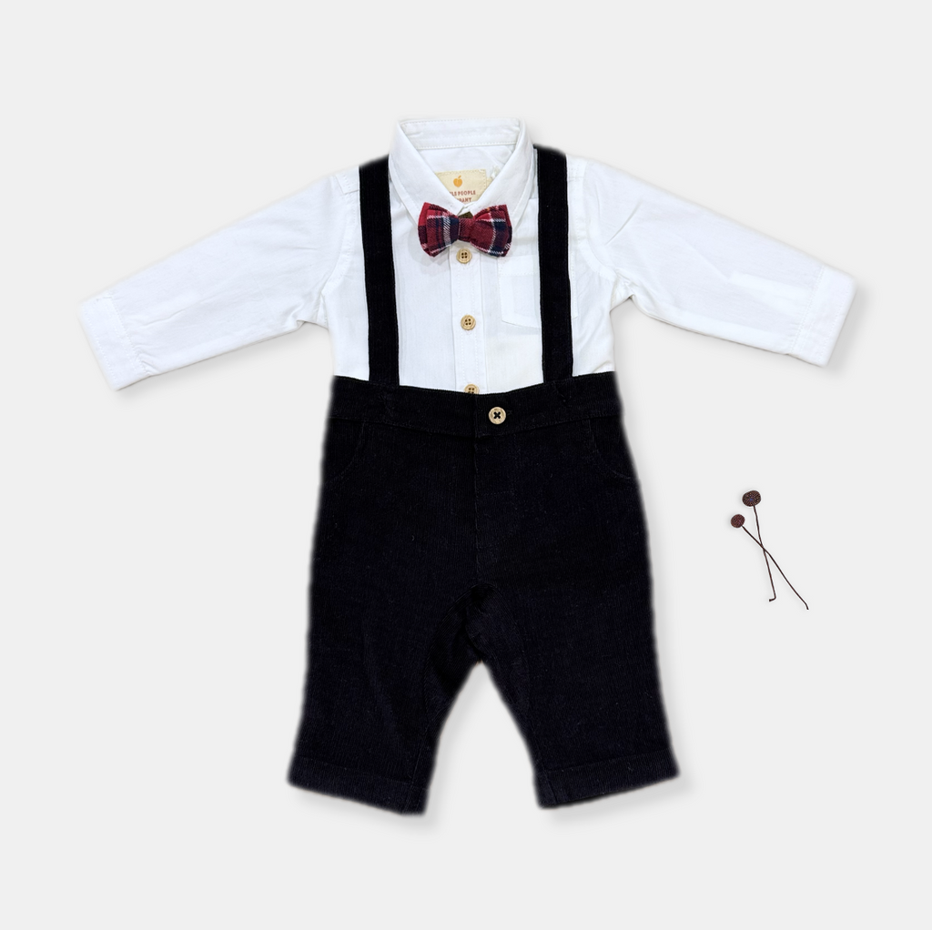 White full sleeve shirt with black corduroy pants with braces and bow tie. perfect first birthday outfit for boys photoshoot.